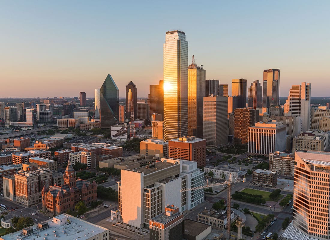 Contact - Aerial View of Commercial Buildings Offices and Skyscrapers in Downtown Dallas Texas at Sunset