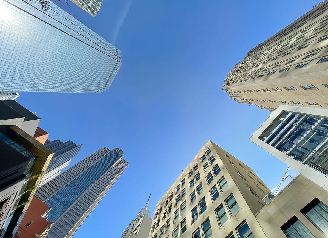 Insurance Solutions - View Looking Up at Modern Skyscrapers in Downtown Dallas Texas Against a Clear Blue Sky